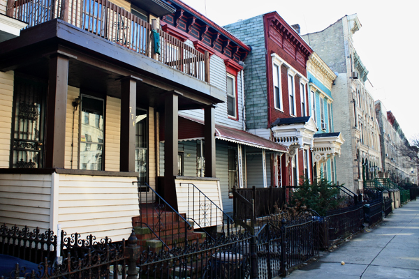Several three-quarter houses occupy a single block of MacDonough Street in Bedford-Stuyvesant. (Some buildings pictured are not three-quarters houses.) The owner of one four-story house has been fined multiple times for building violations.