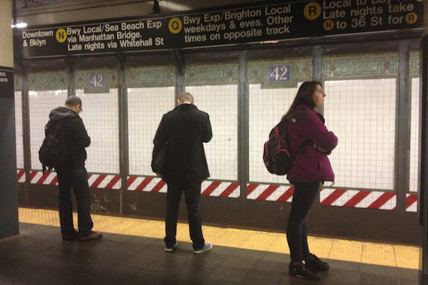 Grand central: Subway riders stand behind the yellow line while they wait for the next southbound N or Q train.