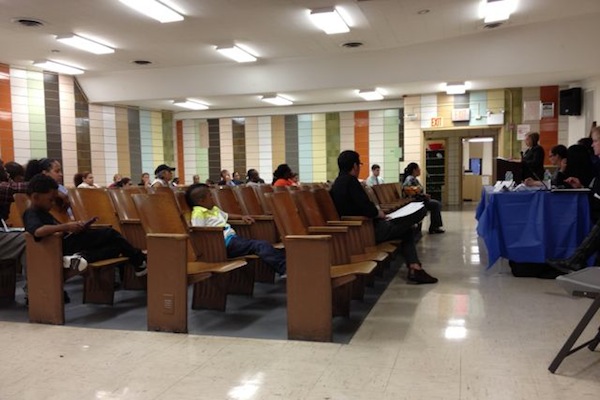Families from PS/IS-377 listen on June 13 as District 32 Superintendent Lillian Druck presents the plan to co-locate Achievement First North Brooklyn Preparatory in the building.