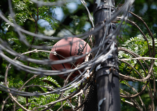 Barbed wire at Bridges Juvenile Facility in the Bronx traps a basketball.