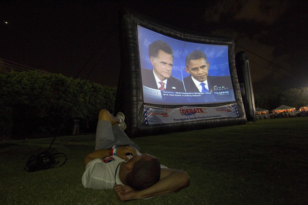 A member of the crowd watches Republican presidential nominee Mitt Romney and President Barack Obama meet in the final U.S. presidential debate in Boca Raton.