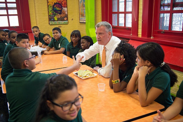 Mayor Bill de Blasio has lunch with students at P.S. 69 in the Bronx during the first-day-of-school five-borough tour. His UPK program, which debuted that day, and affordable housing plan are aimed at reducing the income gap in the city.