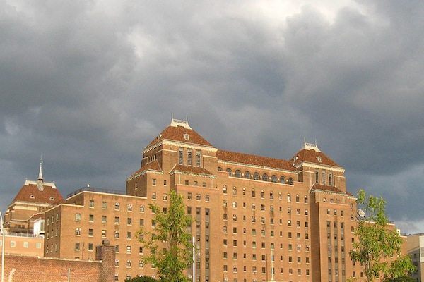 Storm clouds gather over Kings County Hospital Center, a public hospital. While the Health & Hospital Corporation that runs New York City's public hospital system faces its own challenges, other nonprofit hospitals are threatened with closure or merger.