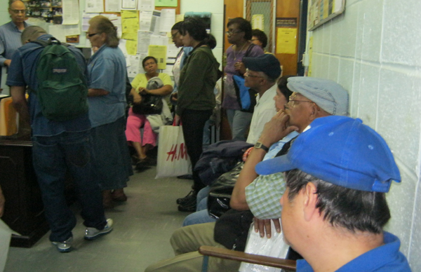 Residents wait early morning in the lobby of the Washington Heights and Inwood Coalition for the housing assistance officer to start work.