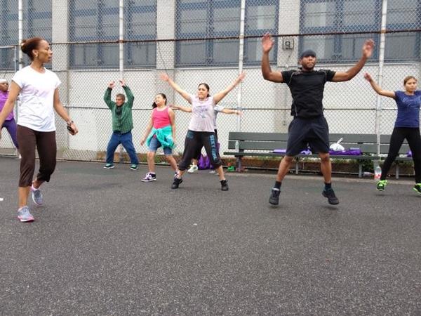 Yvanna Nazaire leads her aerobics class in jumping jacks on a Saturday morning in Bushwick. Her class is part of a Beacon program at IS-291.