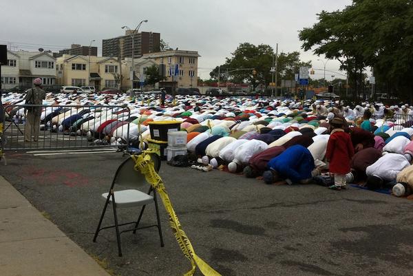 Muslim men, mainly Bangladeshis, observed the end of Ramadan, or Eid, in an East New York parking lot.
