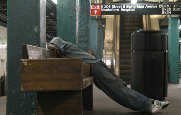 A man sleeps in the Norwood D-train station in 2010. (File)